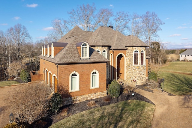 view of front of home featuring a garage and a front lawn