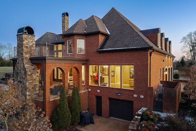 exterior space featuring a garage, a balcony, and central air condition unit