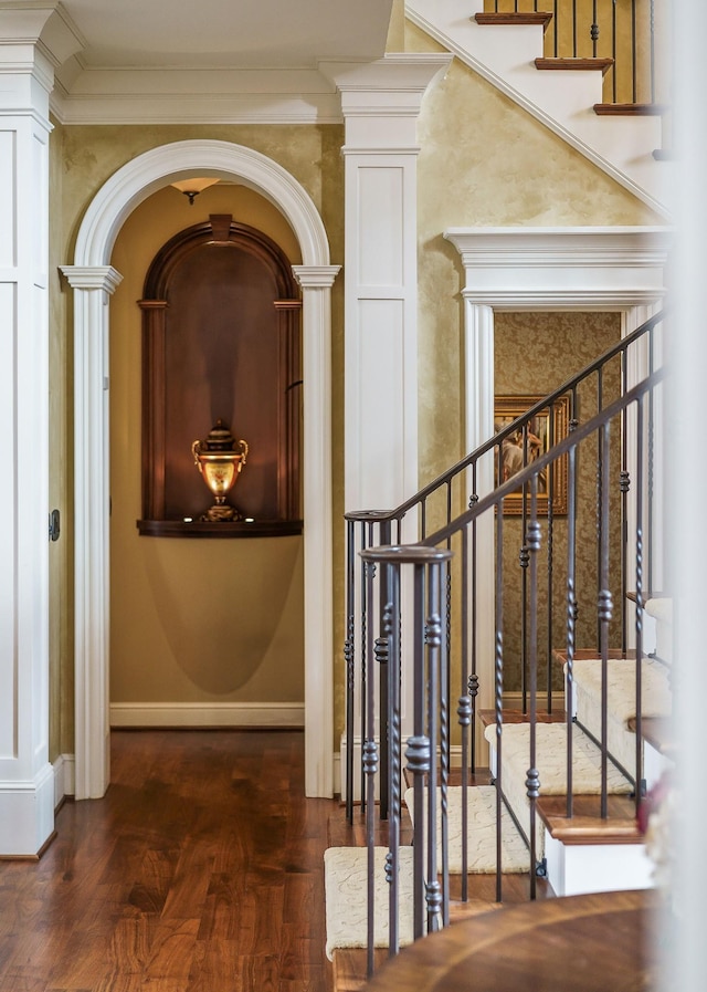 interior space with crown molding and ornate columns