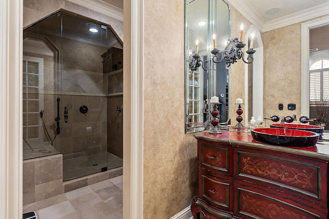 bathroom featuring crown molding, vanity, and a shower with door