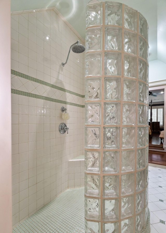 bathroom featuring tile patterned flooring and a tile shower