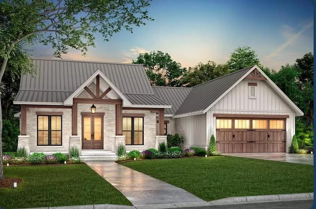 view of front facade featuring a garage, a lawn, and french doors