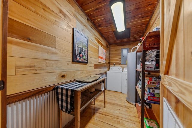 laundry area featuring washer and dryer, wooden walls, electric panel, wooden ceiling, and light hardwood / wood-style flooring