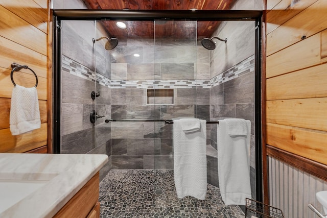 bathroom with vanity and a shower with door