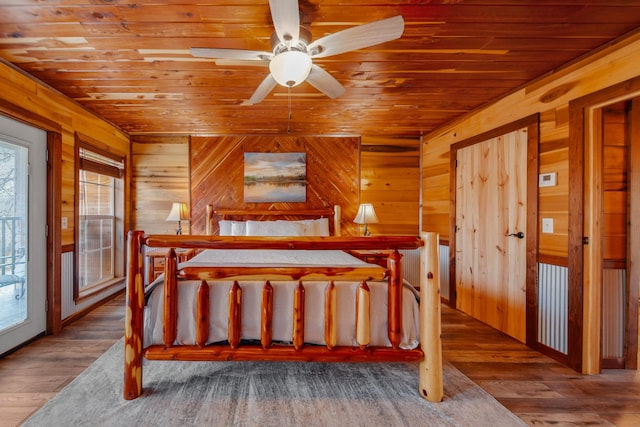 bedroom featuring multiple windows, hardwood / wood-style flooring, wooden ceiling, and ceiling fan