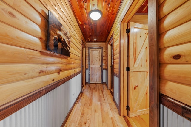 hallway featuring wooden ceiling, rustic walls, and light hardwood / wood-style floors