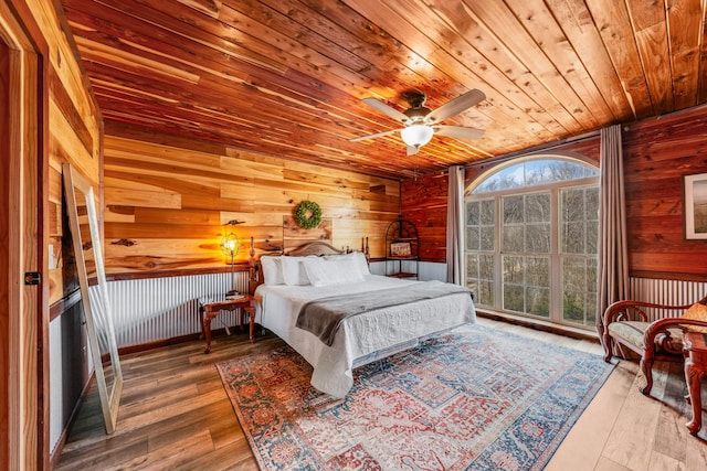 bedroom with wood-type flooring, wooden ceiling, and ceiling fan