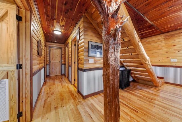 hallway featuring wooden ceiling, log walls, and light hardwood / wood-style floors