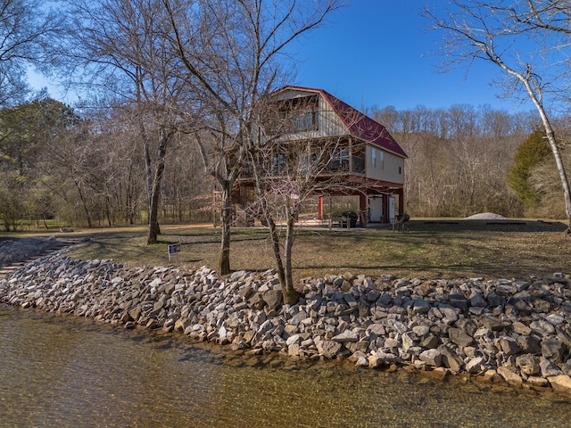 back of property with a lawn