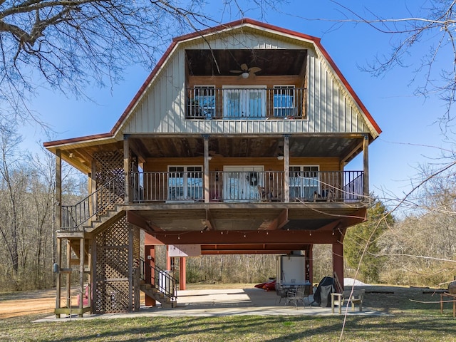 view of front facade with a balcony, ceiling fan, and a patio area