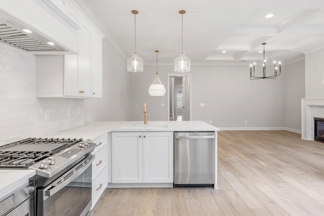 kitchen featuring coffered ceiling, sink, beamed ceiling, stainless steel appliances, and white cabinets