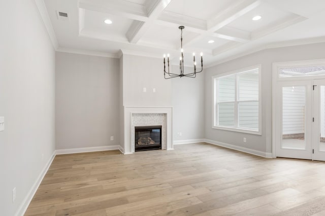 unfurnished living room with ornamental molding, coffered ceiling, beam ceiling, and light hardwood / wood-style flooring