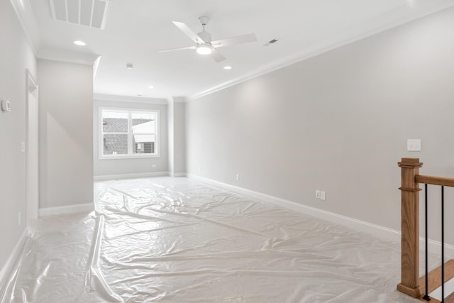 spare room featuring ornamental molding and ceiling fan