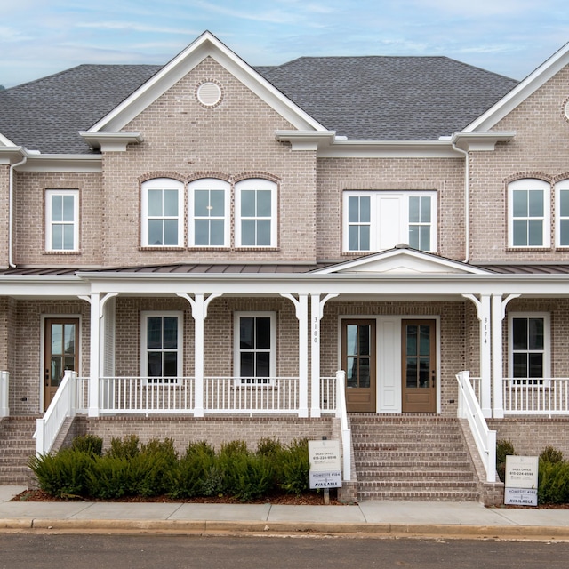 townhome / multi-family property featuring covered porch