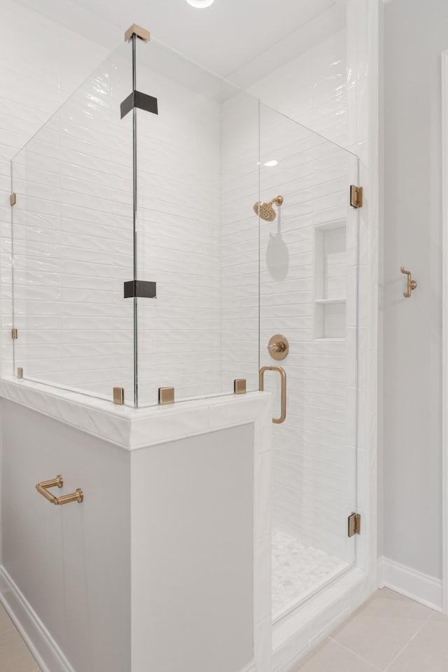 bathroom featuring tile patterned flooring and a shower with shower door