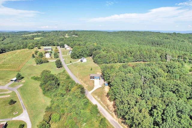 birds eye view of property with a forest view