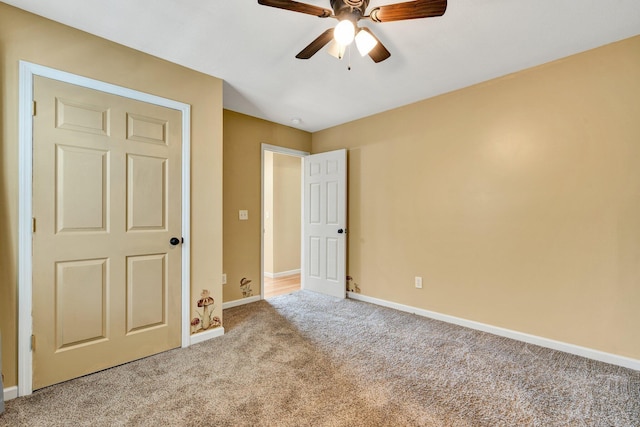 unfurnished bedroom featuring a ceiling fan, light colored carpet, and baseboards