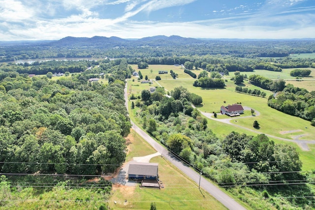 drone / aerial view with a mountain view and a wooded view