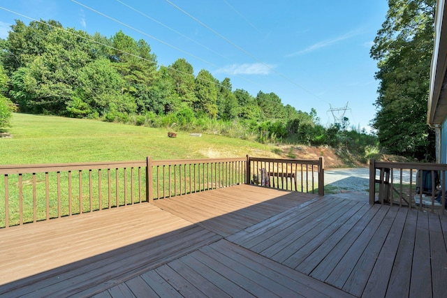 wooden terrace featuring a lawn