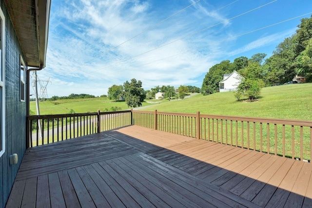 wooden deck featuring a lawn