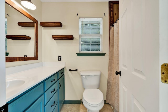 bathroom with toilet, baseboards, and vanity