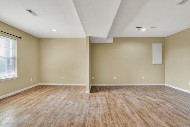 spare room with baseboards, recessed lighting, visible vents, and light wood-style floors