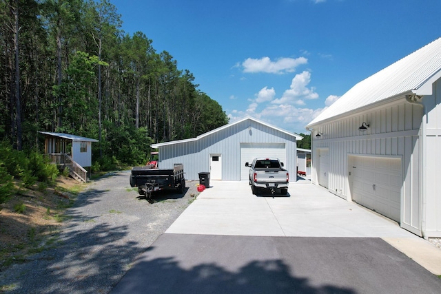 view of side of home featuring a garage and an outdoor structure