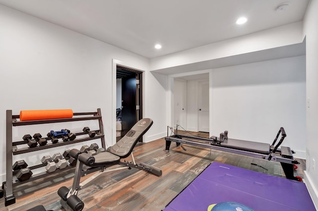 workout area with hardwood / wood-style floors