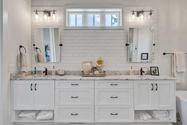 bathroom featuring vanity, a bathing tub, and backsplash