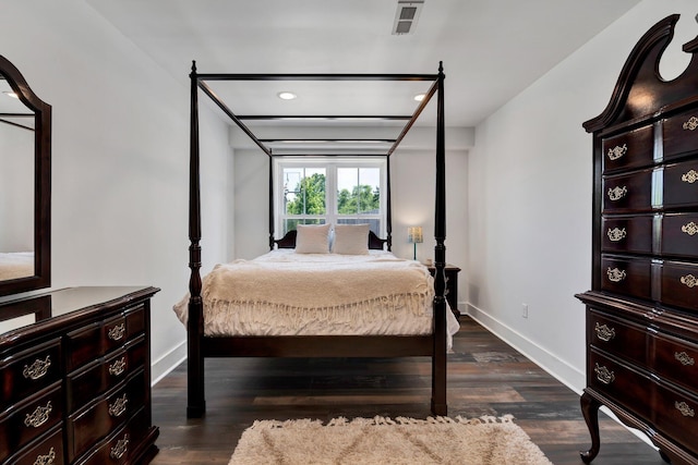 bedroom with dark hardwood / wood-style floors