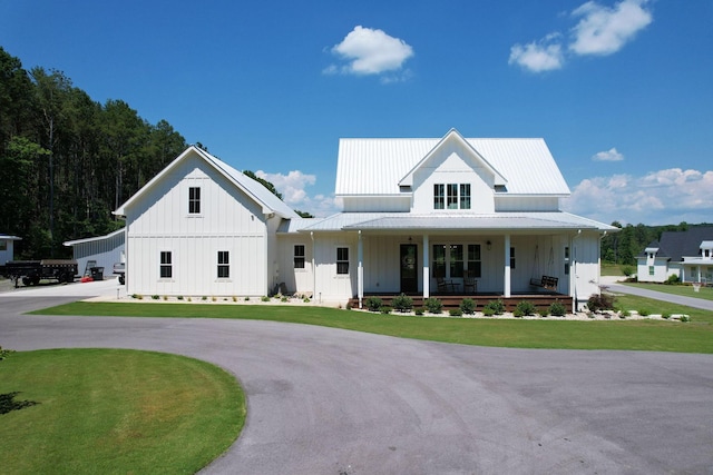 modern inspired farmhouse with a porch and a front yard