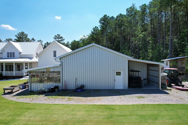 view of outdoor structure featuring a lawn