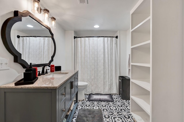 bathroom featuring vanity, tile patterned floors, and toilet