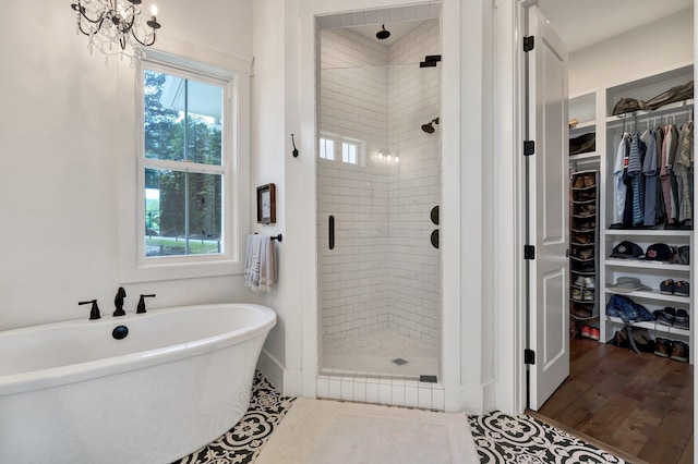 bathroom with plus walk in shower and wood-type flooring