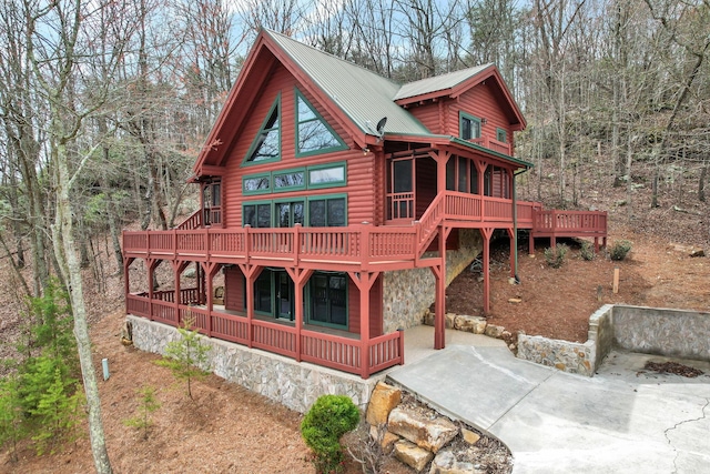 rear view of house featuring a deck