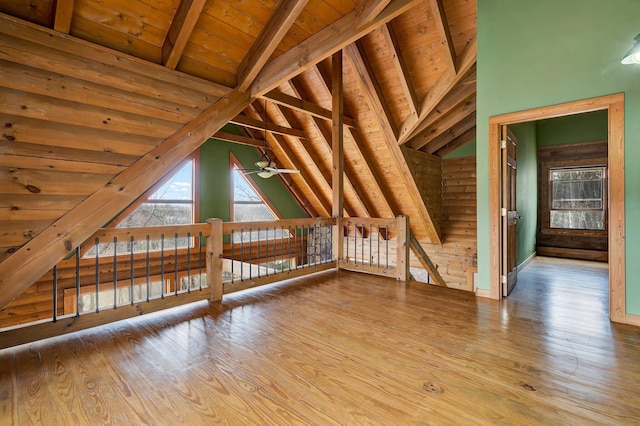 additional living space featuring vaulted ceiling with beams, wood ceiling, wood-type flooring, and ceiling fan