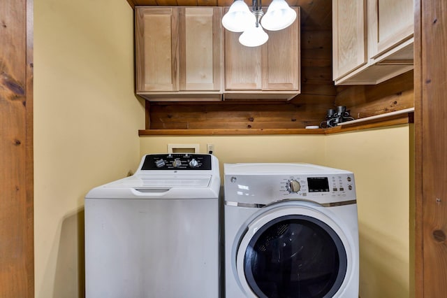 laundry area featuring cabinets and washer and clothes dryer