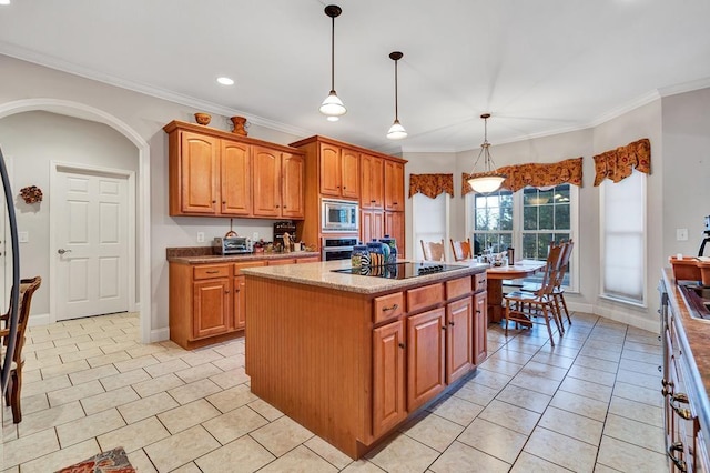 kitchen featuring a kitchen island, appliances with stainless steel finishes, hanging light fixtures, crown molding, and light stone countertops