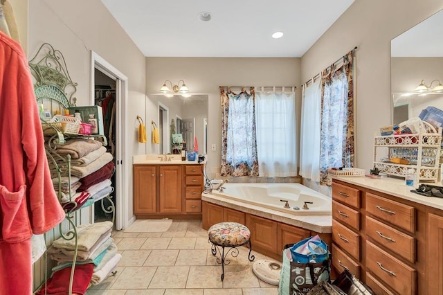 bathroom with vanity, a washtub, and tile patterned floors