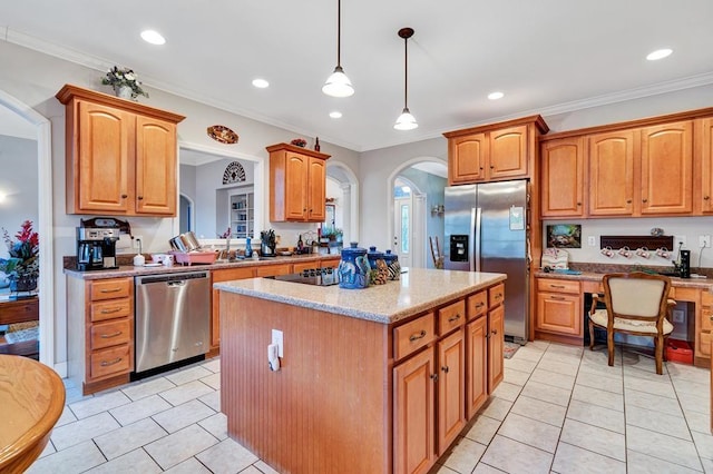 kitchen featuring crown molding, light stone counters, a center island, appliances with stainless steel finishes, and pendant lighting