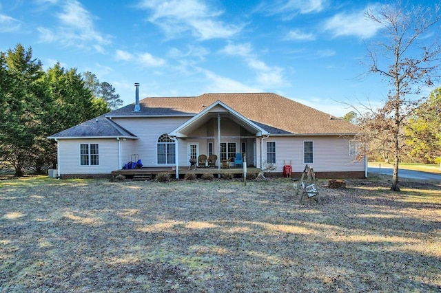 back of property featuring a yard and a deck