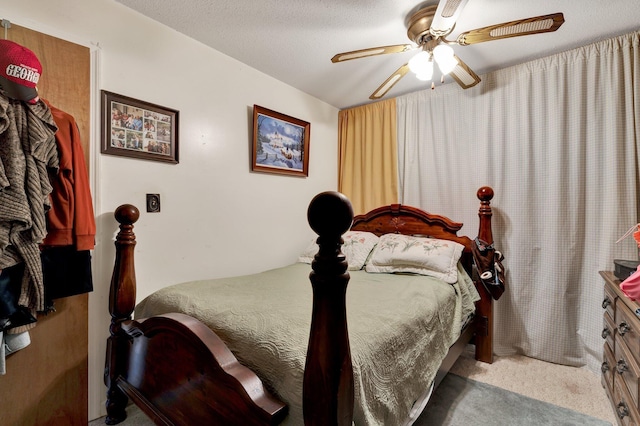 bedroom with light colored carpet, a textured ceiling, and ceiling fan