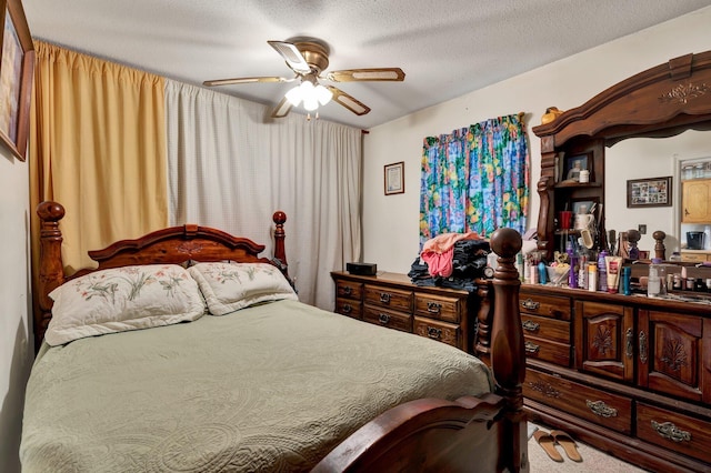 carpeted bedroom with ceiling fan and a textured ceiling