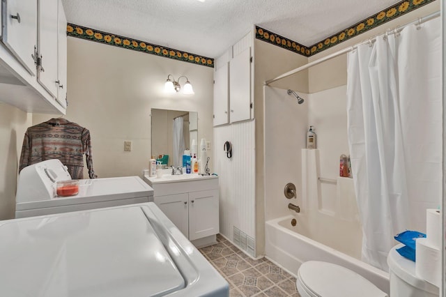 full bathroom featuring shower / tub combo with curtain, separate washer and dryer, vanity, toilet, and a textured ceiling