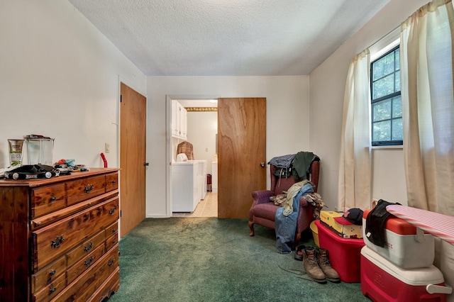 sitting room with washer / clothes dryer, carpet flooring, and a textured ceiling