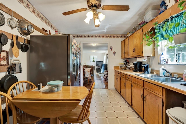 kitchen with stainless steel refrigerator with ice dispenser, sink, and ceiling fan