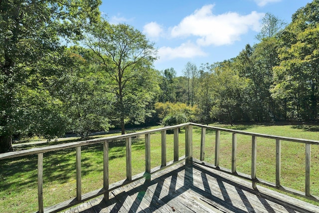 wooden deck with a lawn