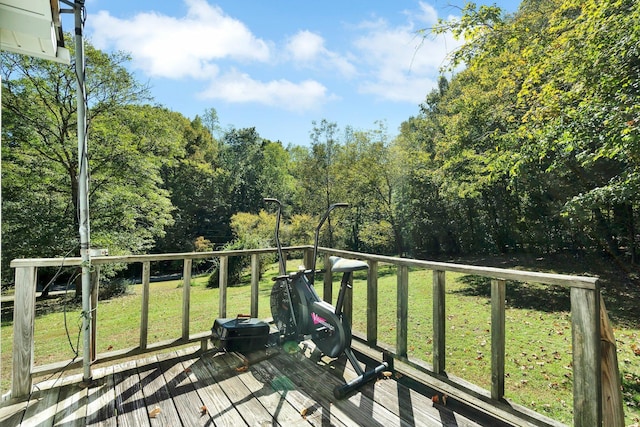 wooden terrace featuring a lawn