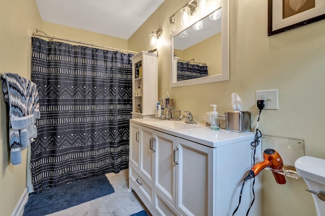 bathroom featuring vanity and curtained shower