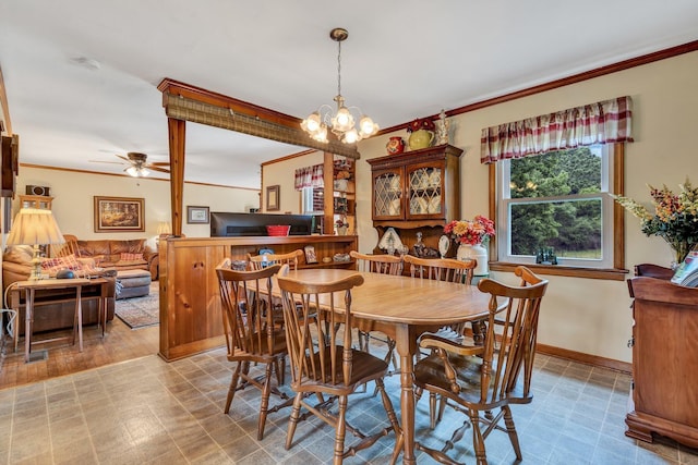 dining area featuring ornamental molding and ceiling fan with notable chandelier